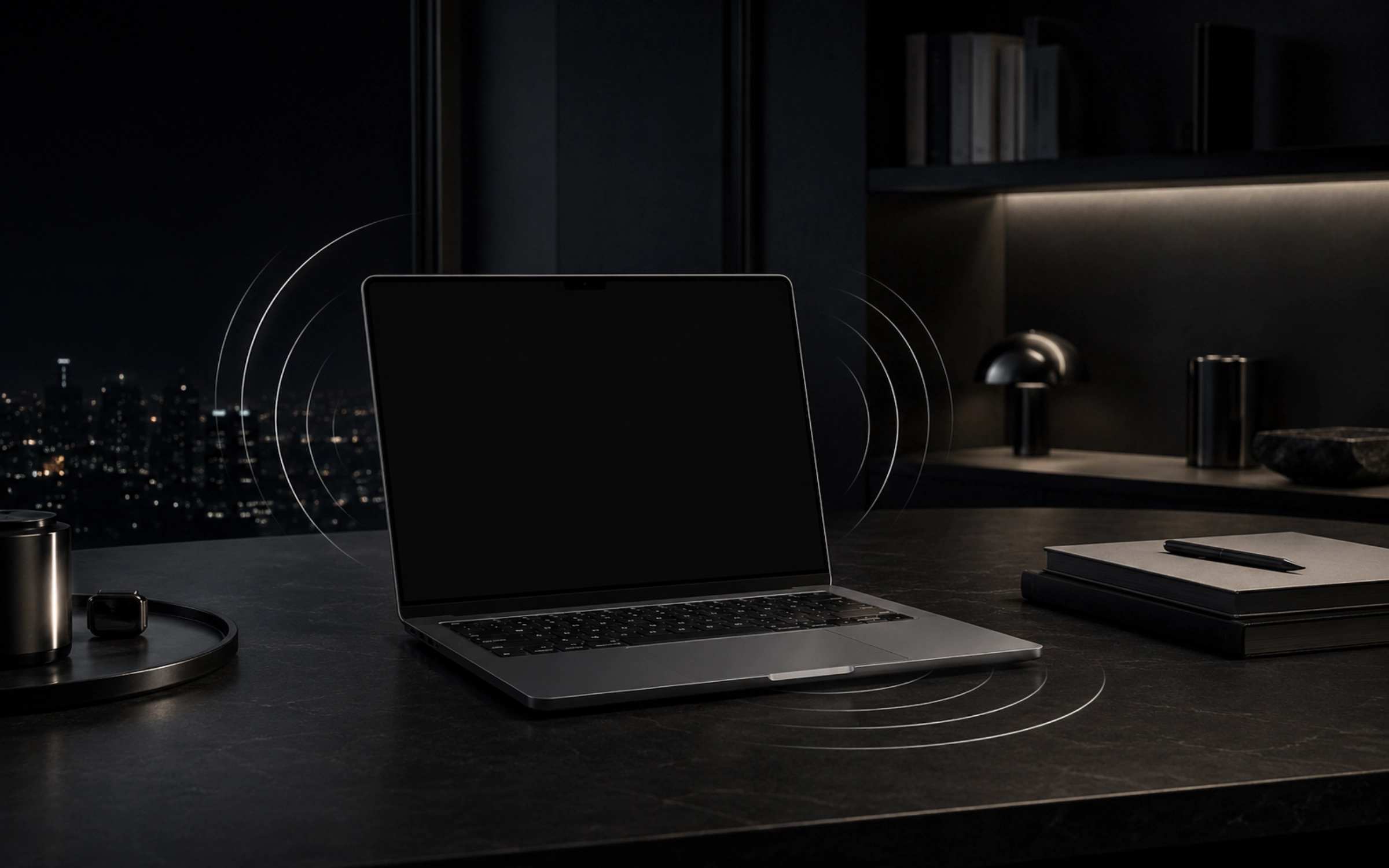 An unattended MacBook on a dark desk with subtle motion-sensing rings